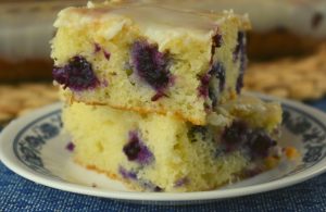 Lemon Glazed Blueberry Cake is a simple Cake Mix Blueberry Cake recipe.  The result is a super moist cake packed with flavor, perfect for breakfast of dessert.