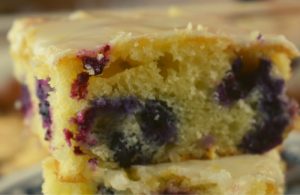 Lemon Glazed Blueberry Cake is a simple Cake Mix Blueberry Cake recipe.  The result is a super moist cake packed with flavor, perfect for breakfast of dessert.