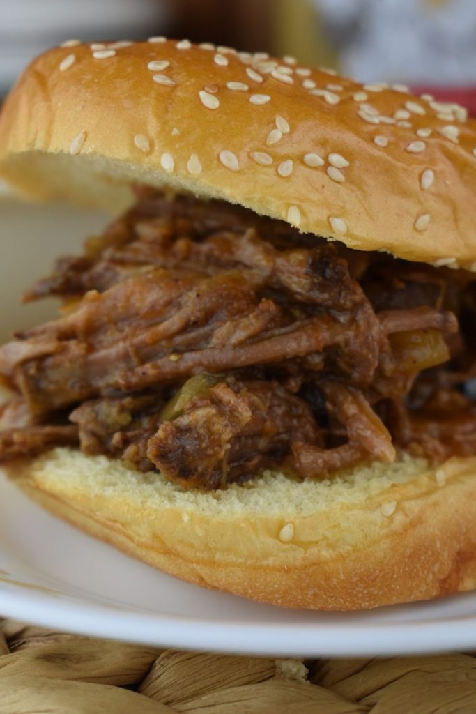 Easy Slow Cooker BBQ Beef creates tasty pulled beef perfect to eat on sandwiches.  Included with this recipe for easy pulled beef are instructions for BBQ shredded beef without the slow cooker.