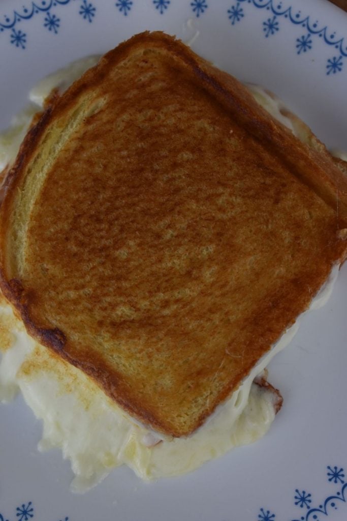 A Croque Monsieur is a French sandwich often found in bistros. Think about it as a hot hand cheese sandwich made on thicker, white bread with the cheese being more of a white sauce called béchamel sauce.