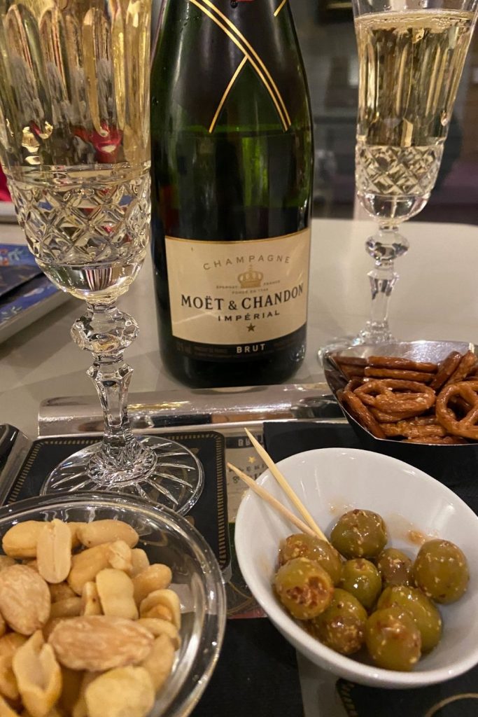 A tray of snacks of nuts, pretzels and olives goes well with champagne.