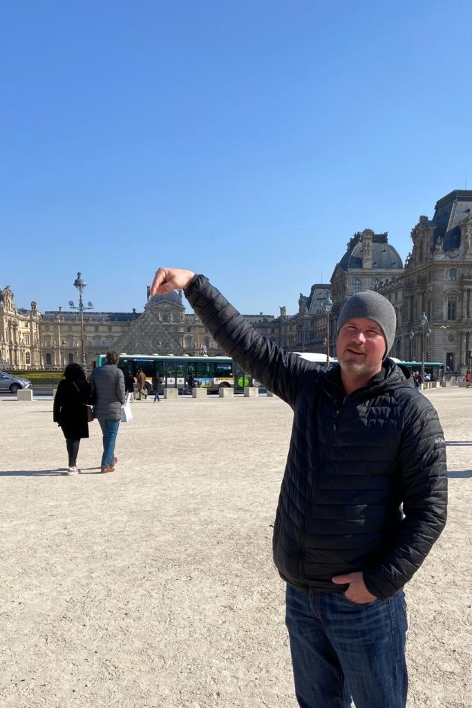 Take a fun photo in front of the Louvre when you are visiting Paris.