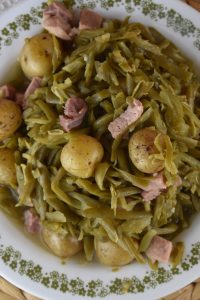 Crock Pot French Style Green Beans is the perfect recipe to bring to any large gathering or holiday event.  These Slow Cooker Green Beans With Potatoes and Ham can be put in the crock pot in the morning and are ready for lunch with minimal effort.