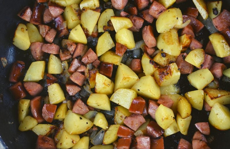 Fried potatoes with smoked sausage and onions is a delicious meal that you can whip up in no time. This tasty dish could be served as breakfast, lunch or dinner.