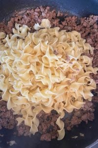 Ground Beef and Noodles is a hands-down favorite dinner for kids.  This recipe for hamburger and noodles could not be any easier to make, and it gets gobbled up in no-time. Save this to your quick ground beef dinner recipe box.