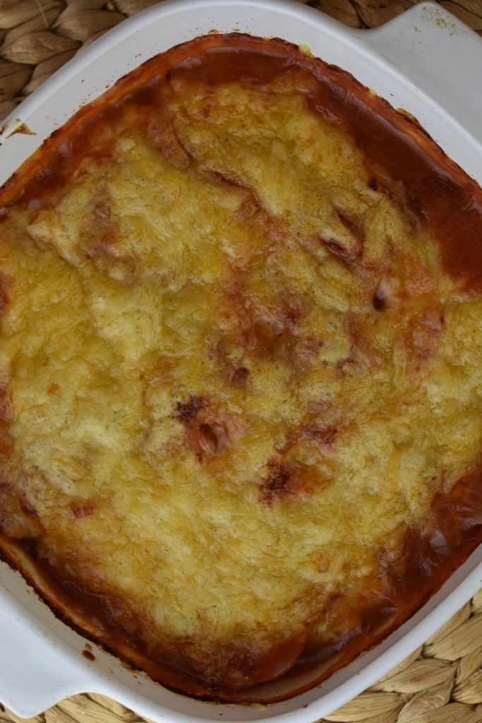 These pizza potatoes are made in a 2-quart casserole dish and covered with cheese.