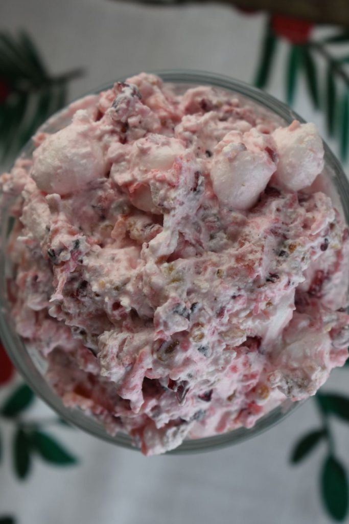 This old school cranberry salad is flavored with fresh cranberries that get ground up into small pieces. The result is a perfectly pink color that accents the entire dinner table.