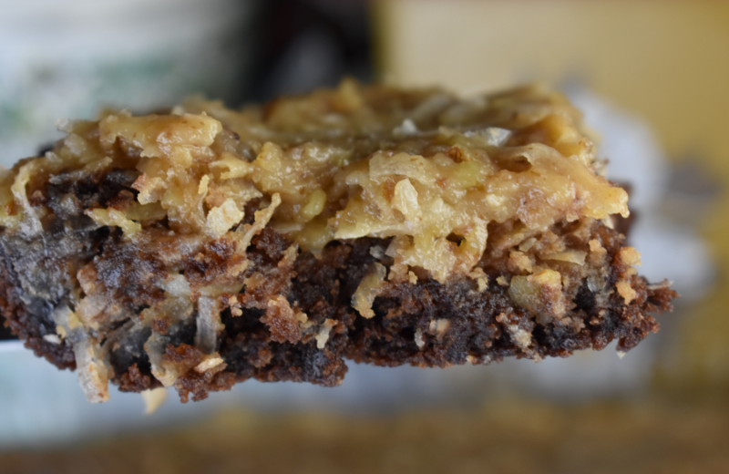 Loaded German Chocolate Brownies not only have that classic icing filled with nuts and coconut on top but also swirled through the gooey center. These German chocolate brownies are made from a box mix.