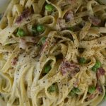 Hay and Straw Pasta is a fan favorite among.  Cooked fettuccine with bacon and peas gets smothered in a cheesy Parmesan sauce.