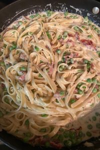 Hay and Straw Pasta is a fan favorite among.  Cooked fettuccine with bacon and peas gets smothered in a cheesy Parmesan sauce.