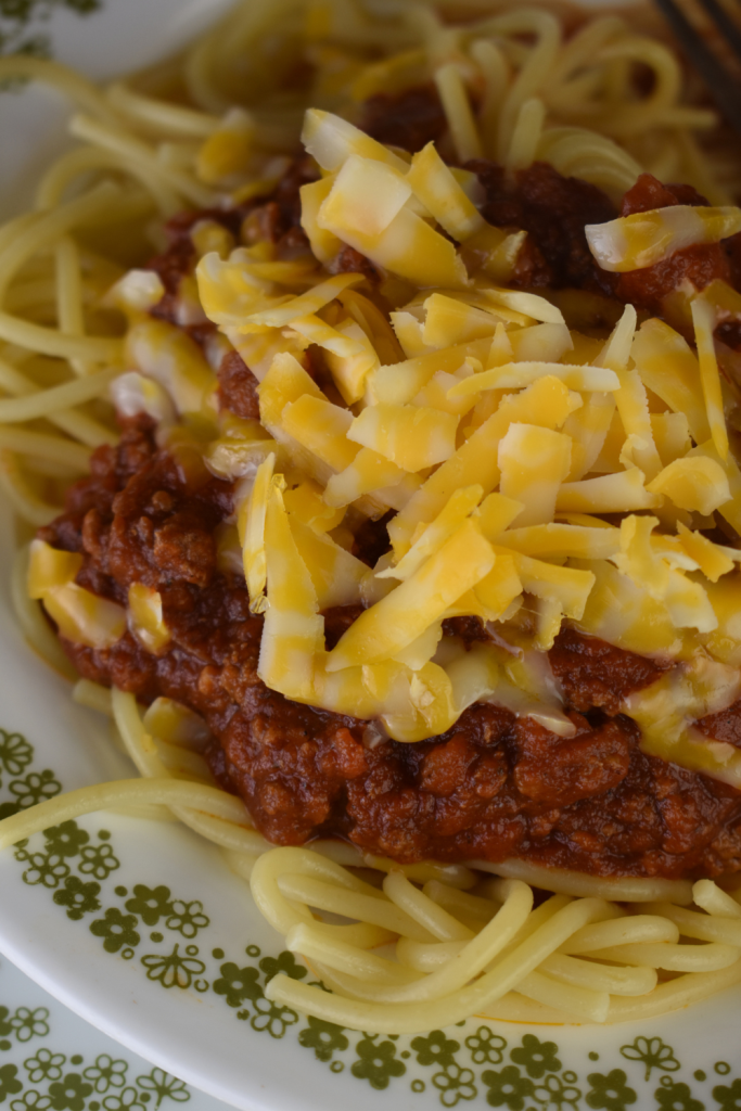 Cincinnati Chili recipe consists of a thick, spicy chili recipe served over spaghetti noodles, and then topped with shredded cheddar cheese.