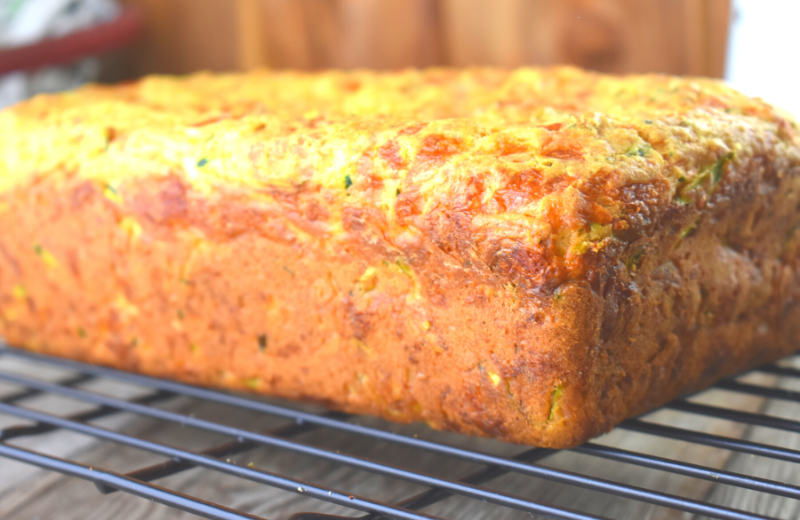 This cheesy zucchini bread has a golden brown exterior and a moist herb-flavored interior.