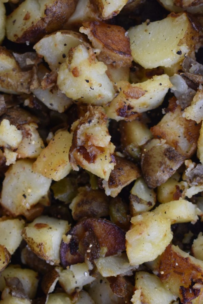 Breakfast Potatoes with Peppers and Onions (also known as skillet potatoes) is the perfect side dish for any time of day. Made on the stove top, this easy home fries recipe is a hit no matter what time of day you make it. 