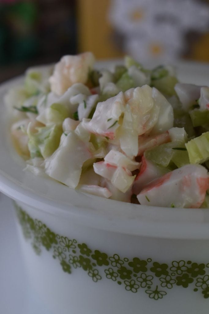 This cold seafood salad has a lovely lemon dressing and features cooked shrimp and imitation crab meat.