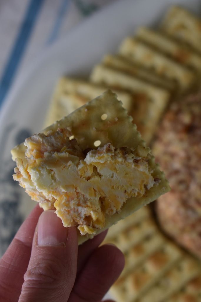 Cheese ball spread on a cracker