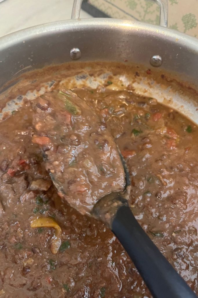 pot of easy black bean soup with serving spoon