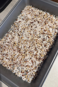 This German chocolate gooey layer cake is a vintage recipe made with cake mix, coconut, pecans, and a rich cream cheese filling.
