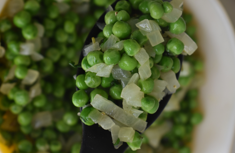 spoon with minted peas and caramelized onions