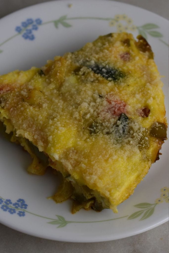 Slice of spring garden frittata on a plate 