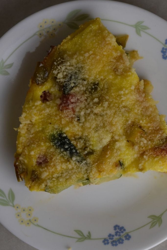 Slice of spring garden frittata on a plate 